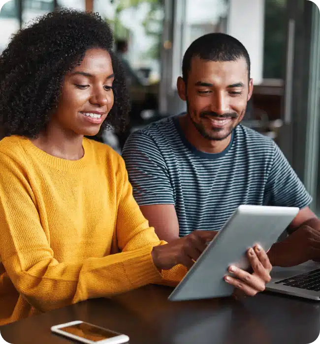 man and woman looking at tablet